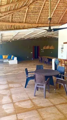 a group of tables and chairs in a room at Estero View Beach House in Barra de Santiago