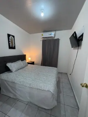 a small bedroom with a bed and a television at Casa Monaco in San Miguel