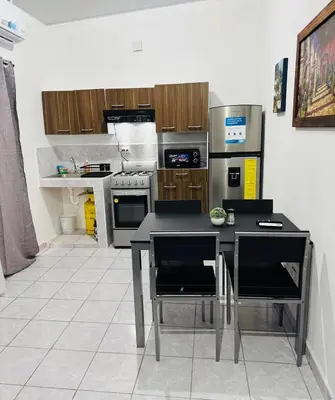 a kitchen with a table and chairs in it at Casa Monaco in San Miguel