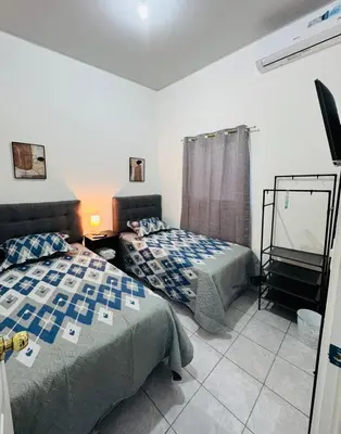 a bedroom with two beds and a mirror in it at Casa Monaco in San Miguel