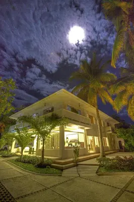 a house with a full moon in the sky at Boca Olas Resort Villas in La Libertad