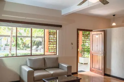 a living room with a couch and a window at Boca Olas Resort Villas in La Libertad