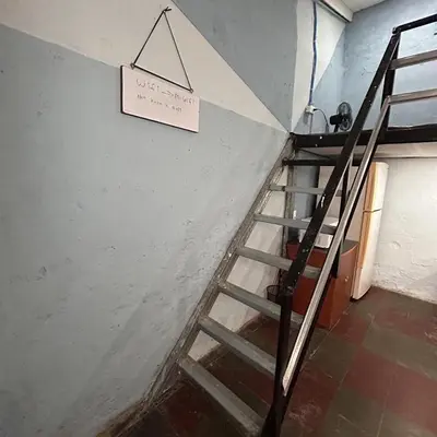 a staircase in a room with a sign on the wall at La Casita de Nataly in Santa Ana