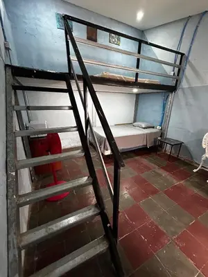 a staircase leading to a bunk bed in a room at La Casita de Nataly in Santa Ana