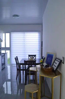 a kitchen and dining room with a table and chairs at sophia by aby House in San Miguel