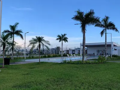 a park with palm trees and a building at sophia by aby House in San Miguel