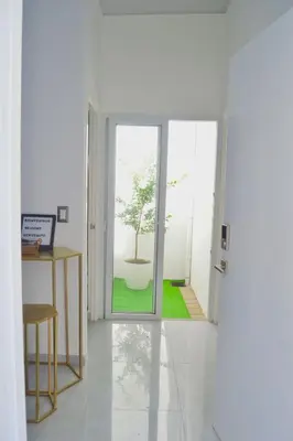 a white room with a bonsai tree in a pot at sophia by aby House in San Miguel