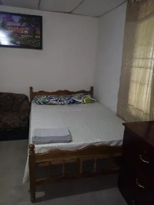 a small bedroom with a bed and a couch at Casita d Playa 1 in La Esmeralda