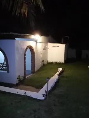 a house with a light on the side of it at night at Casita d Playa 1 in La Esmeralda