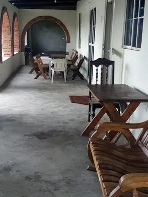 a room with wooden tables and chairs and a chalkboard at Casita d Playa 1 in La Esmeralda