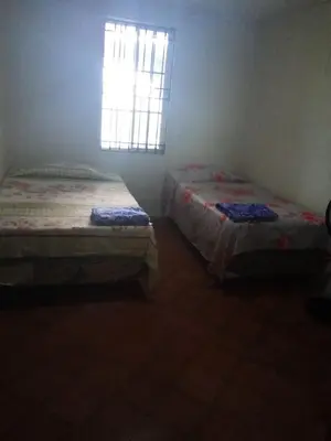 two beds in a room with a window at Casita d Playa 1 in La Esmeralda