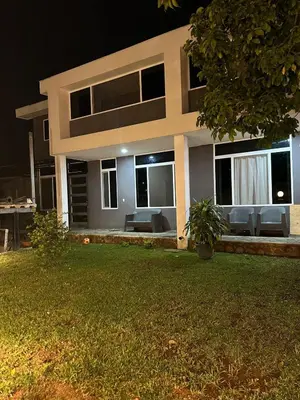 a house with a lawn in front of it at night at Moderno & acogedor Apartmento, 2 habitaciones , 4 camas in Concepción de Ataco
