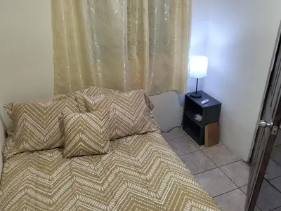a bed with two pillows on it in a bedroom at Copinol 68 in San Salvador