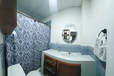 a bathroom with a sink and a mirror at Altagracia Altagracia in Santa Ana