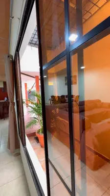 a view of a bedroom through a glass window at SimpleSerenity Country House in Juayúa