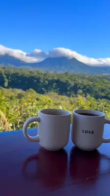 two white coffee cups sitting on top of a table at SimpleSerenity Country House in Juayúa