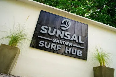 a sign on the side of a building at SunSal Garden Surf Hub in El Sunzal
