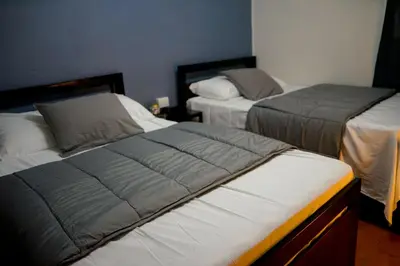 two beds in a room with two beds sidx sidx sidx at SunSal Garden Surf Hub in El Sunzal