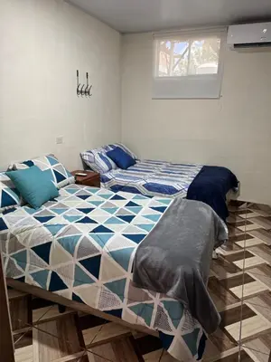 a bedroom with two beds and a window at Cozy house in the center of San Vicente in San Vicente