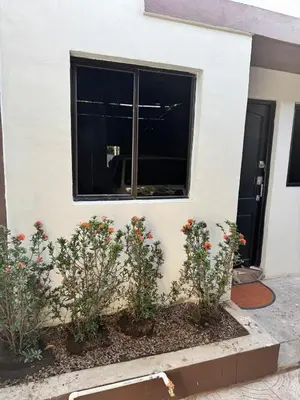 a building with flowers in front of a window at Cozy house in the center of San Vicente in San Vicente