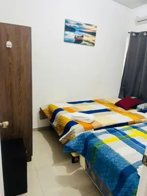 a bedroom with a bed and a picture on the wall at VillaOriental in San Miguel