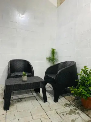 two chairs and a coffee table in a patio at VillaOriental in San Miguel