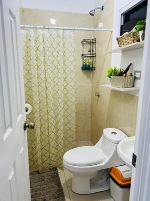 a bathroom with a toilet and a shower at VillaOriental in San Miguel