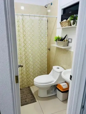 a bathroom with a toilet and a shower at VillaOriental in San Miguel
