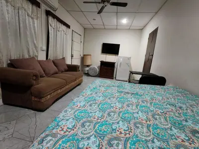 a living room with a couch and a rug at Casa de Mario in Santa Ana