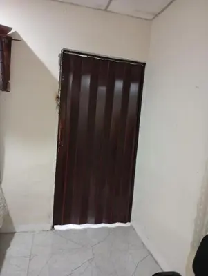 a brown door in a room with a white wall at Casa de Mario in Santa Ana