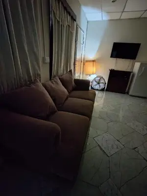 a living room with a couch and a tv at Casa de Mario in Santa Ana