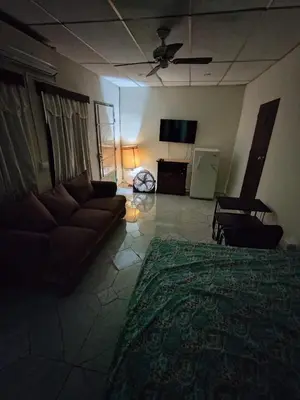 a living room with a couch and a flat screen tv at Casa de Mario in Santa Ana