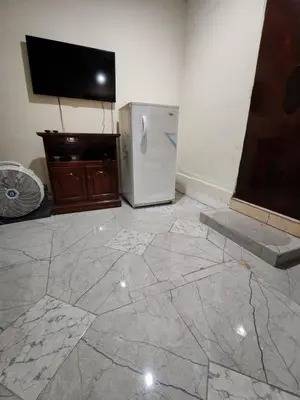 a kitchen with a white refrigerator and a tv at Casa de Mario in Santa Ana