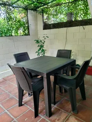 a black table and chairs on a patio at Copinol 68 in San Salvador