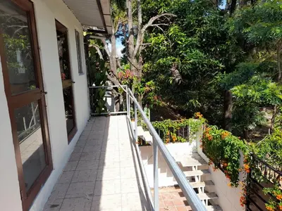 a stairway leading up to a house with flowers at Copinol 68 in San Salvador