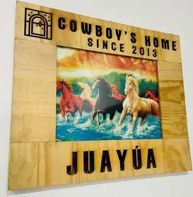 a sign with horses running in the water at Cowboys Home in Juayúa
