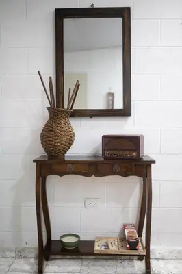 a table with a mirror and a clock on it at Cowboys Home in Juayúa