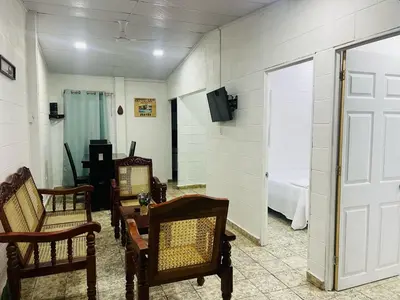 a room with chairs and a door and a bed at Cowboys Home in Juayúa
