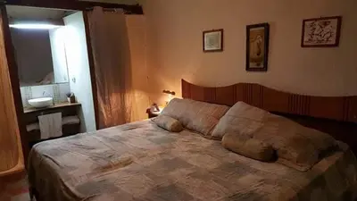 a bedroom with a large bed in a room at Casona los Vega in Izalco