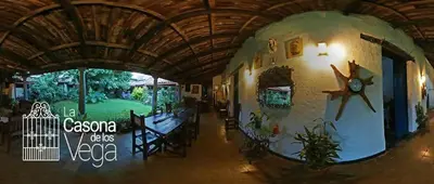 a hallway of a house with a clock on the wall at Casona los Vega in Izalco