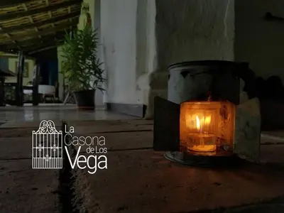 a candle sitting on the ground in a room at Casona los Vega in Izalco