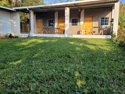 a house with a lawn in front of it at Mi pueblo Hostal Nahuizalco in Nahuizalco