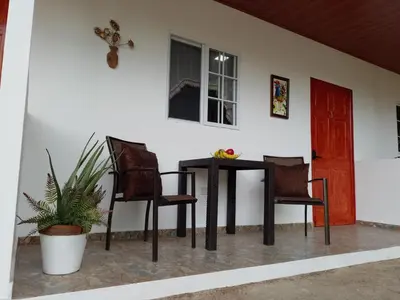 a black table and two chairs and a red door at Sunzal Refugio Perfecto-3 in El Sunzal