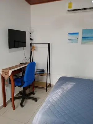 a bedroom with a desk and a blue chair at Sunzal Refugio Perfecto-3 in El Sunzal