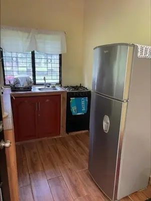 a kitchen with a stainless steel refrigerator and a stove at DONDE ANTONIO BARRA DE SANTIAGO in Barra de Santiago