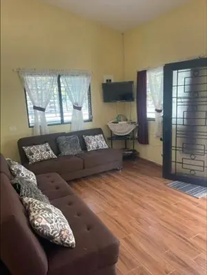 a living room with a couch and two windows at DONDE ANTONIO BARRA DE SANTIAGO in Barra de Santiago