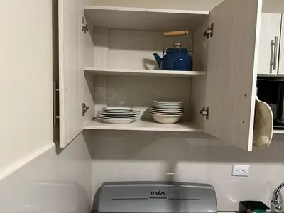 a kitchen cabinet with plates and dishes in it at Placentero y acogedor apartamento en Calle Monserrat in San Salvador