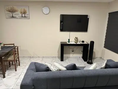 a living room with a blue couch and a tv at Placentero y acogedor apartamento en Calle Monserrat in San Salvador