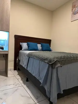 a bedroom with a large bed with blue pillows at Placentero y acogedor apartamento en Calle Monserrat in San Salvador