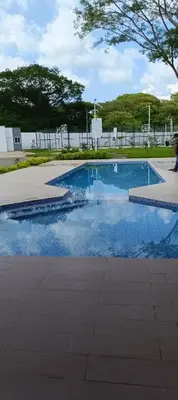 a swimming pool with blue water in a park at Casa de Reyes in San Miguel